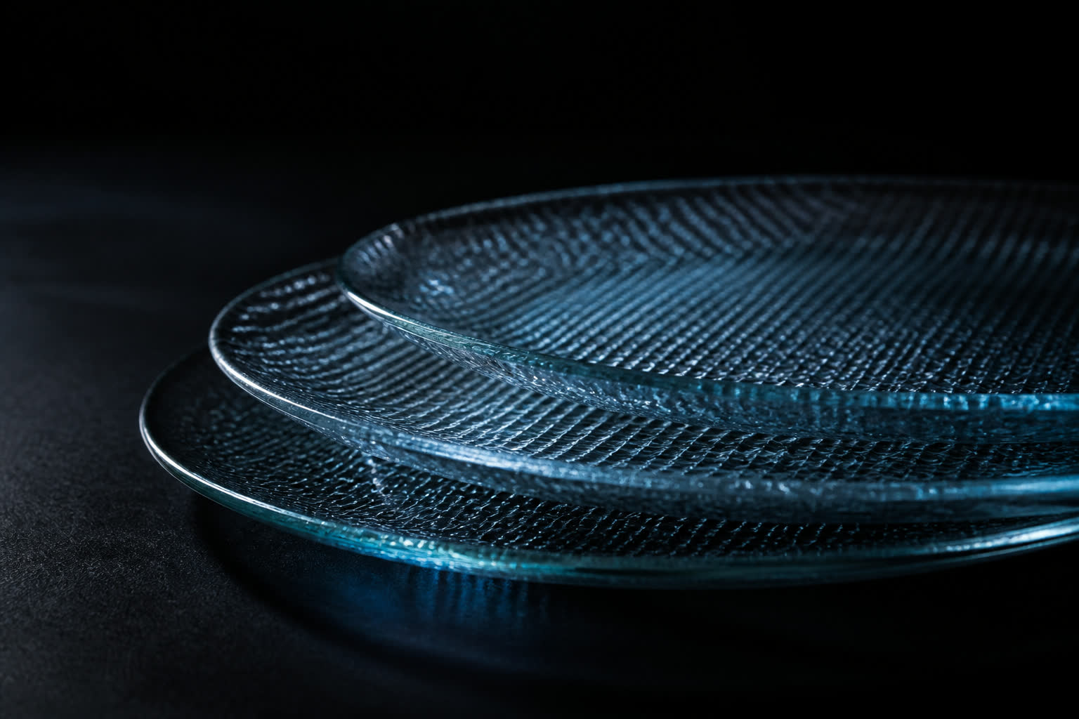 Layered glass plates with a faint lattice, lit by a cold blue edge